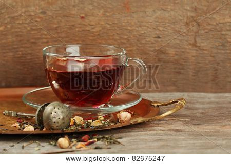 Beautiful vintage composition with herbal tea, on wooden table