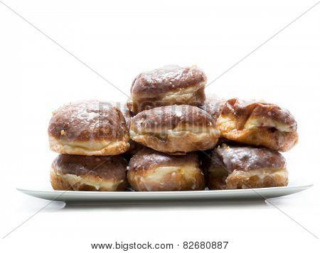 Pile of Polish donuts on plate shot on white                               