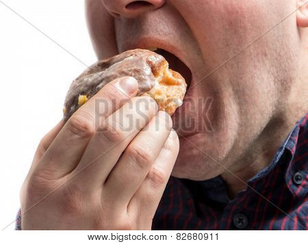 Side shot of man eating donut shot on white                            