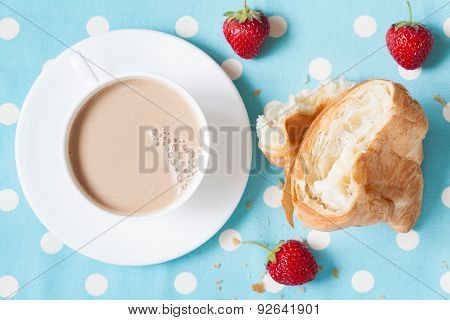 Concept perfect lunch or breakfast. A cup coffee latte with a piece of traditional French croissant