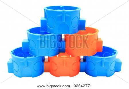 Stack Of Blue And Orange Electrical Boxes. White Background