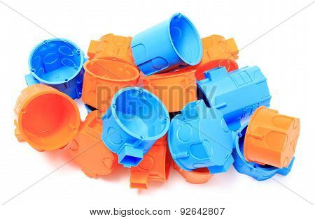 Heap Of Orange And Blue Electrical Boxes On White Background