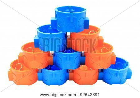 Stack Of Blue And Orange Electrical Boxes. White Background