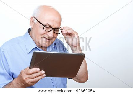 Pleasant grandfather surfing through the Internet