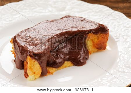 Homemade Baked Pudding With Chololate Icing On White Plate