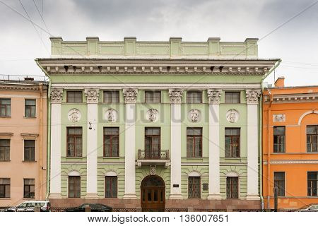 Green classic house with pilasters on the Moika River.