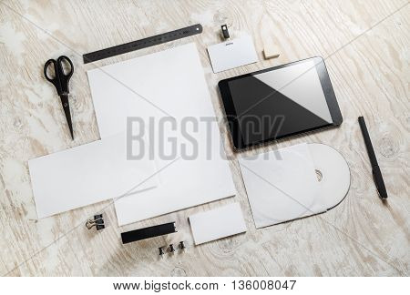 Photo of blank stationery set and corporate identity template on light wooden background. Responsive design template. Mock-up for branding identity. Blank template for your design.
