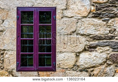 Purple Window On Medieval Castle Made Of Stone And Rocks.
