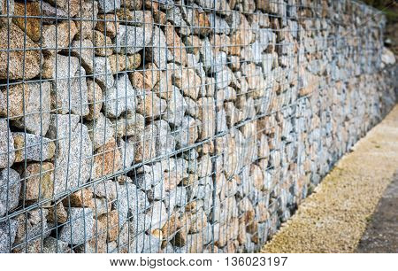 Wire Gabion Rock Fence. Metal Cage Filled With Rocks.