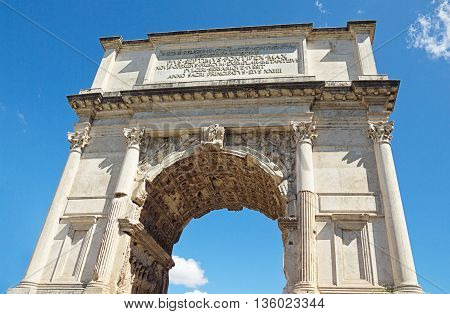 The Arch of Titus at Forum Roman bottom-up view over blue sky background Rome Italy