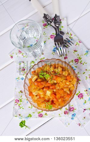 Vegetable stew with sauce on wooden background. Selective focus.