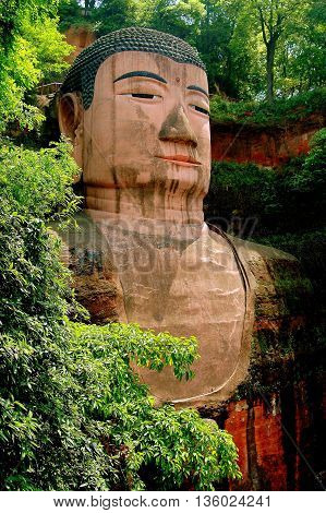 Leshan China - April 25 2005: Begun in 713 A. D. the giant Buddha of Leshan carved into a riverside cliff stands 71 meters high