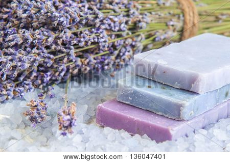Natural soap, lavender, salt on a wooden board, hygiene items for bath and spa. Relax concept.