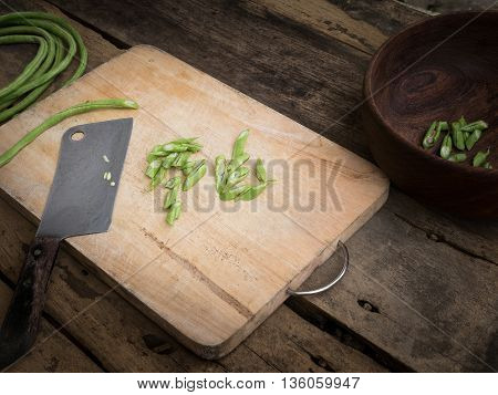 stil life yardlong bean slice on Chopping board wood.