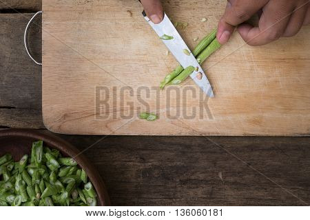 stil life yardlong bean slice on Chopping board wood.