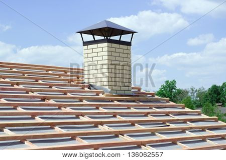 chimney with light brick newly built cottage with no roof tiles