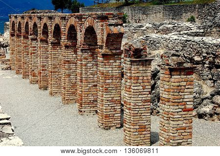 Sirmione Italy - June 1 2006: Ruins of the Roman villa which belonged to the poet Catullus at the Grottoes of Catallus overlook Lake Garda