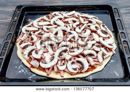 Chef lays out the mushrooms onto the prepared cake