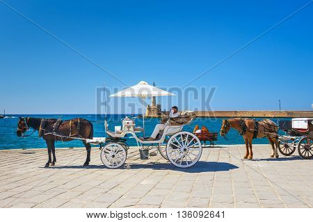 Chania, Crete - 23 Maj, 2016: Horse Carriage For Transporting Tourists In Old Port Of Chania On Cret
