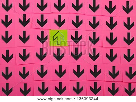 Arrows. Opposite direction concept. Background of pink sticky notes.