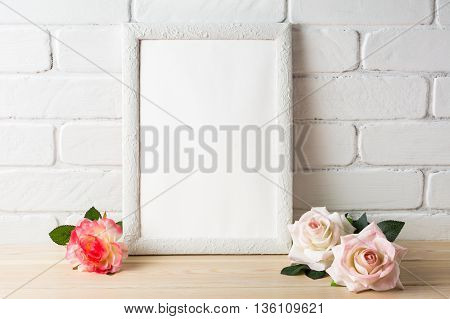 White frame mockup with roses. Empty white frame mockup for design presentation. Portrait or poster white frame romantic style mockup