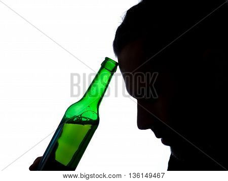 Silhouette of aman with a bottle of beer
