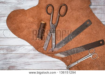 A lot of work tools and leather for shoemaker.Leather craft.
