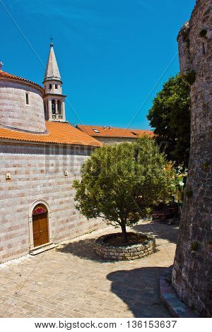Ancient Holy Trinity Church in Budva, Montenegro. Patio. Old town. Artistic retouching.