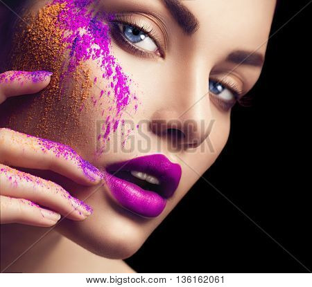 High fashion model girl portrait with colorful powder make up. Beauty woman with bright color makeup. Close-up of Vogue style lady face, Abstract colourful make-up, Art design. Black background