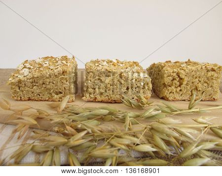 Homemade oatcake and oats on wooden board
