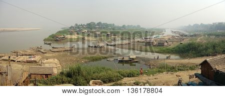 Slum village near the river in the Mandalay city in Myanmar Burma