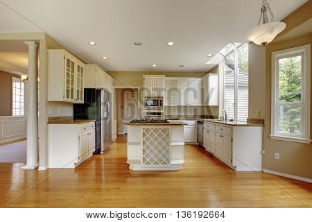 Small Classic American Kitchen Interior With White Cabinets And Hardwood Floor..