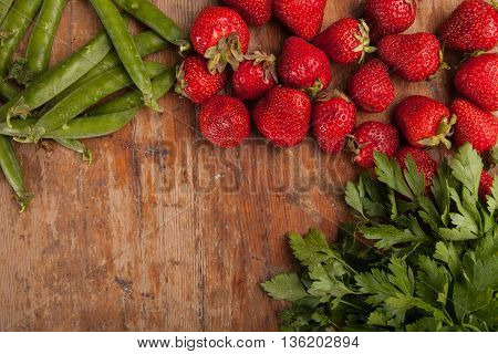 Italian food background, with vine tomatoes, basil, spaghetti, mushrooms, olives, parmesan, olive oil, garlic, peppercorns, rosemary, parsley and thyme. Slate background.