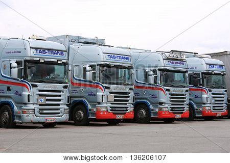FORSSA, FINLAND - JUNE 24, 2016: Fleet of light blue Scania R truck tractors parked on asphalt yard