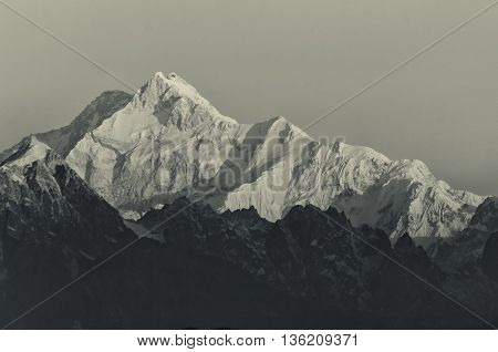 Beautiful first light from sunrise on Mount Kanchenjugha Himalayan mountain range Sikkim India. Tinted stock image.