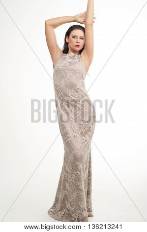 fashion model posing in studio, she wear evening dress