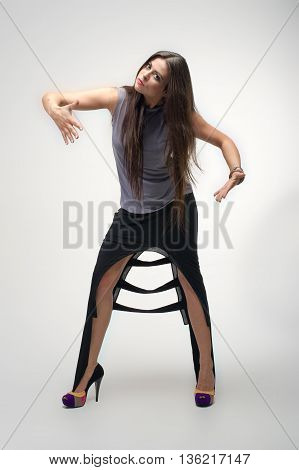 beautiful young girl posing to camera in fashion dress
