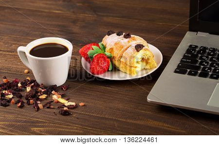 breakfast work with coffee and croissant. notebook