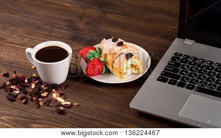 breakfast work with coffee and croissant. notebook