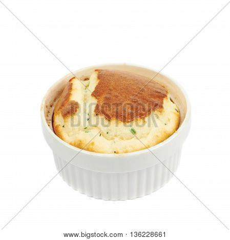 Cheese souffle in a white ceramic ramekin, composition isolated over the white background