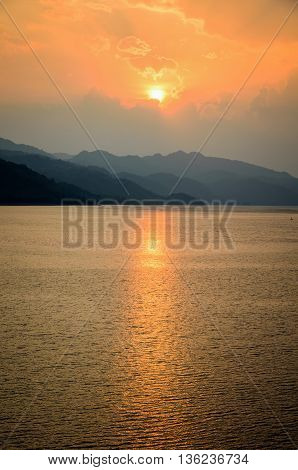 Beautiful landscape during sunset over a mountain ranges at lake in Srinakarin Dam Kanchanaburi Province Thailand