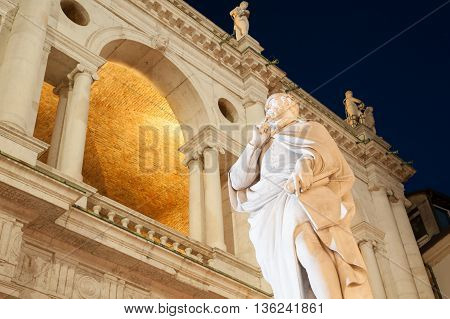Night view of the statue of the famous renaissance architect Palladio and part of the Palladian basilica