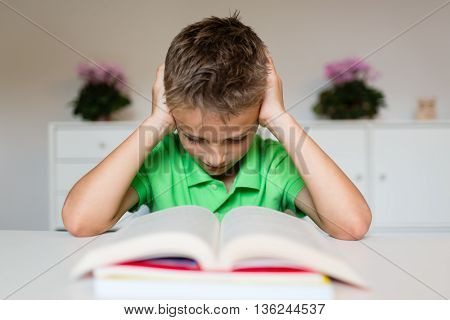 Frustrated Young Boy With Book