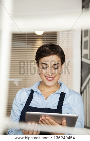 Fashion Designer Using Digital Tablet At Factory