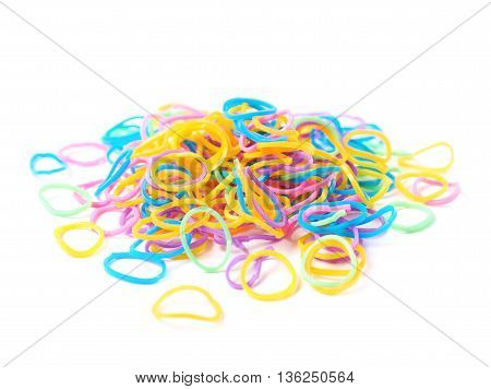Pile of multiple colorful rubber toy loom bands isolated over the white background