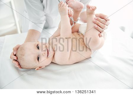 Doctor doing exercises with baby