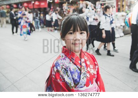 Beautiful Asian girl wearing red kimono walking in the city Asakusa Tokyo Japan.