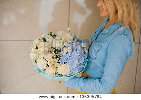 girl holding Bouquet of white and blue flowers