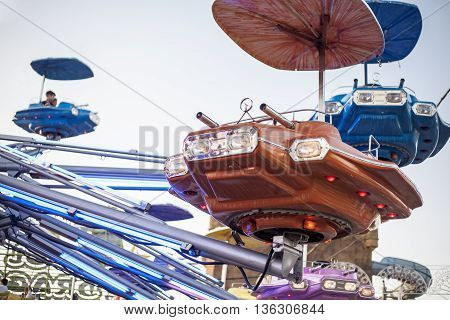 Vintage ship space funfair attraction at dusk Spain