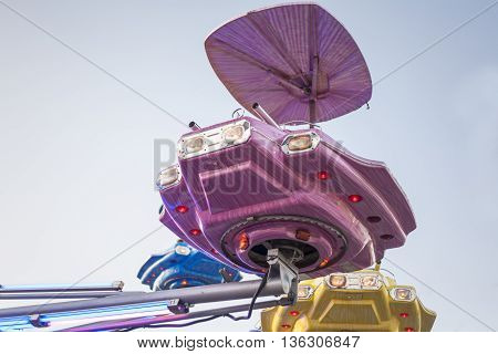 Vintage ship space funfair attraction at dusk Spain